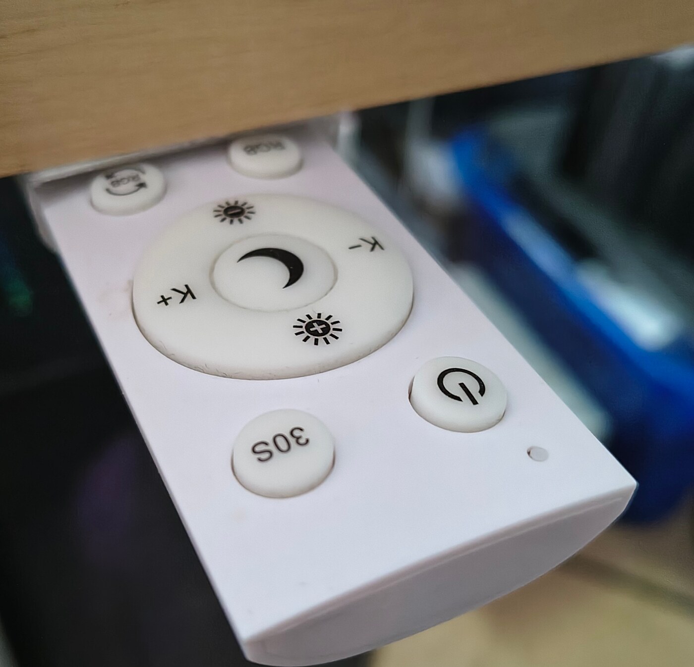 the remote slid halfway out of its printed cradle